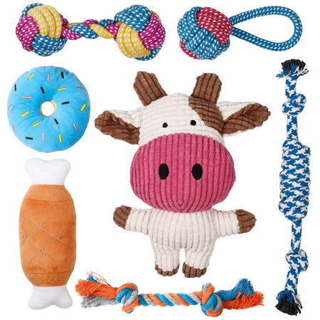 Assorted dog toys including a cow-shaped toy, rope toys, and a plush donut toy 